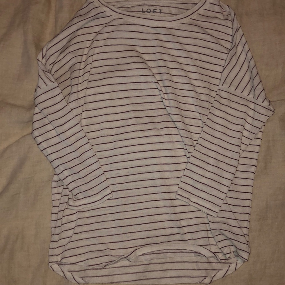Ivory sweater with eggplant purple stripes.